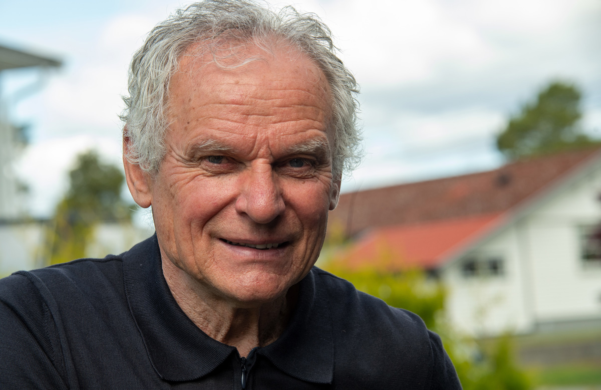 portrait of man, blue jumper with collar and grey hair