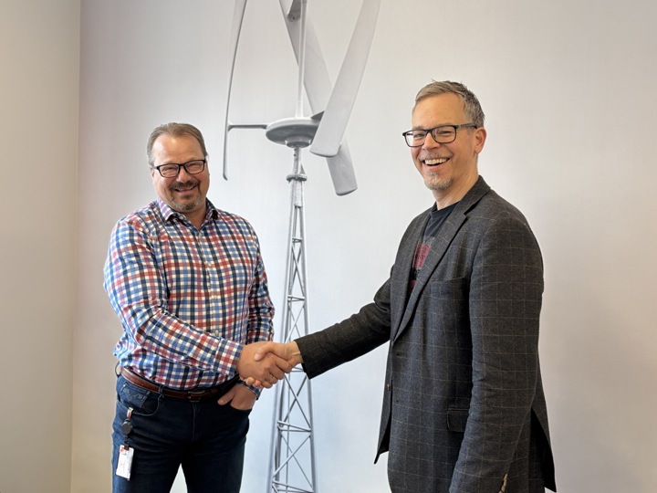 two men shaking hands, deal, posing, smiling.