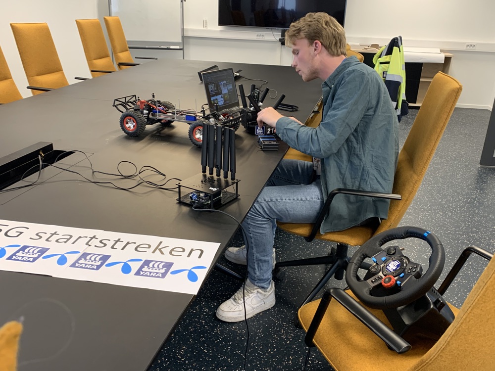 student is testing and preparing a model car for driving on the 5G network
