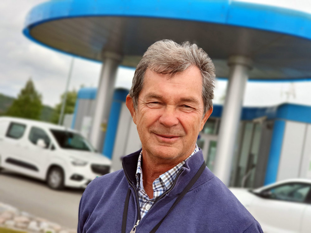 man in front of hydrogen station