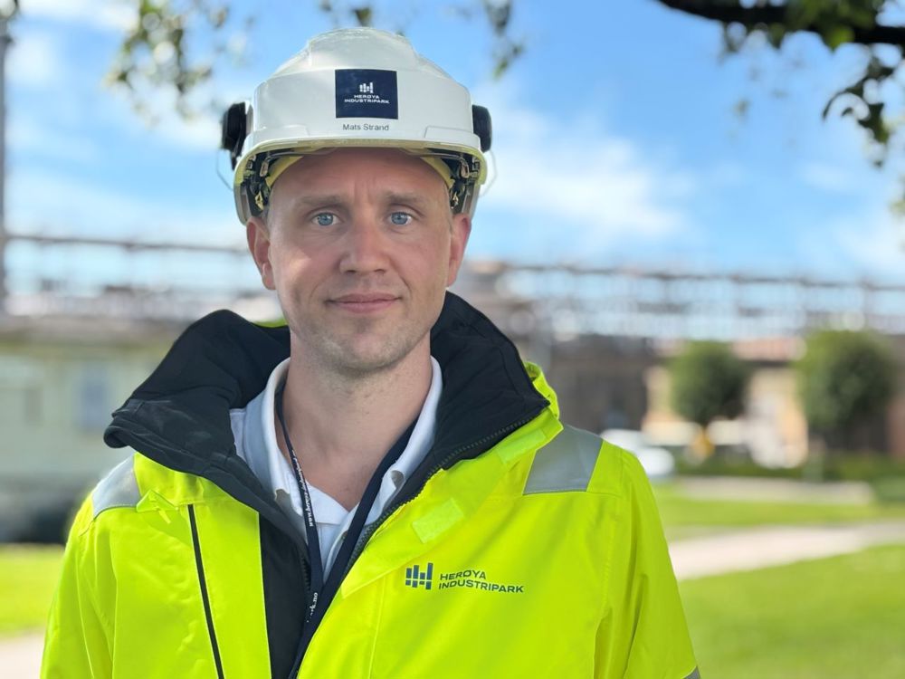 young man, posing, white helmet, yellow jacket, green lawn in background