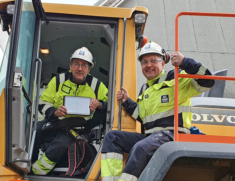 two men sitting on a wheel loader