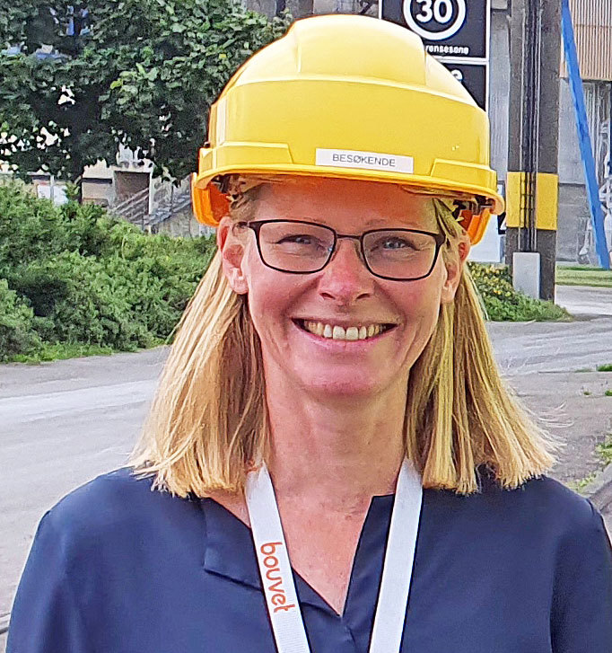 woman wearing glasses and a yellow helmet
