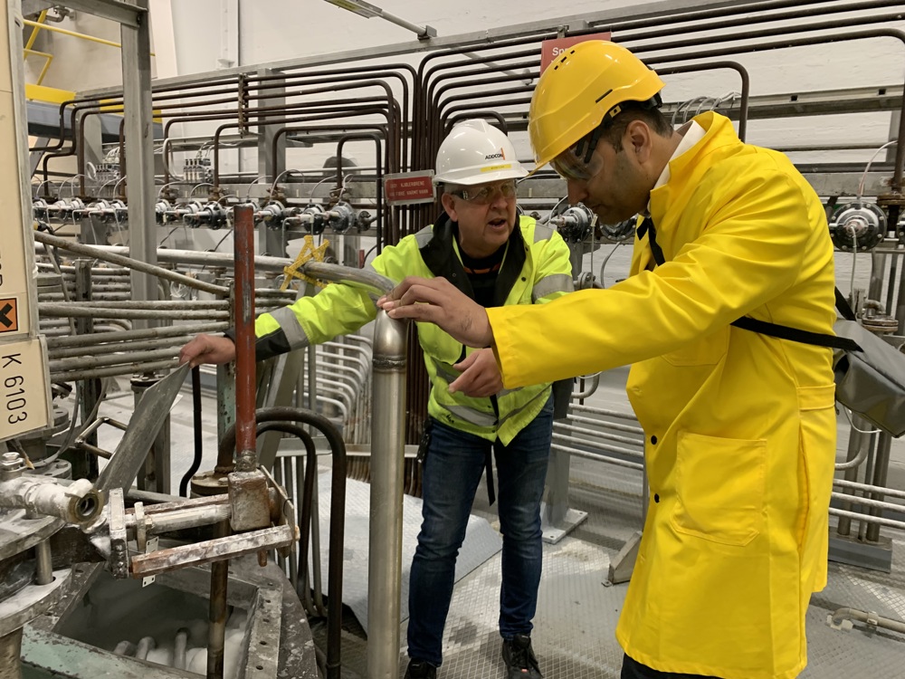 two men studying production of biocarbonate in production facilities.