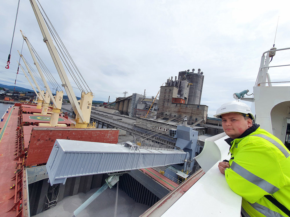 man standing on ship's bridge