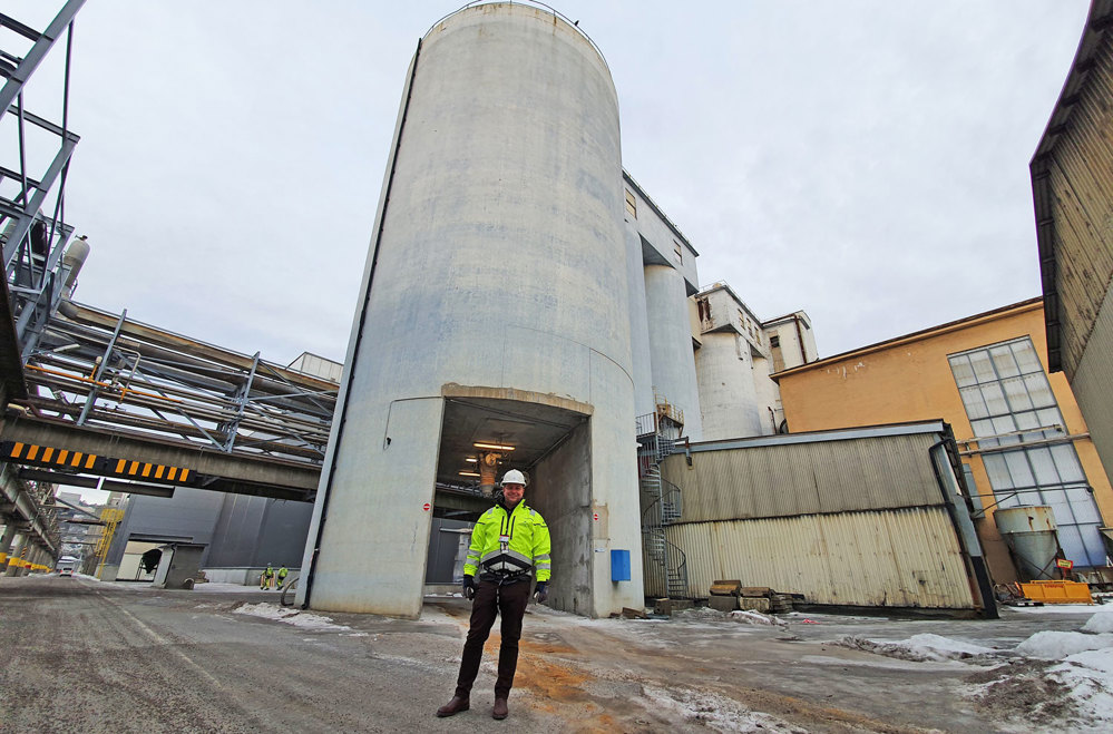 man in front of concrete silo