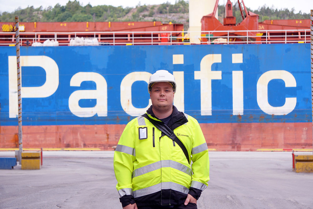 man on the quay, vessels longside in background