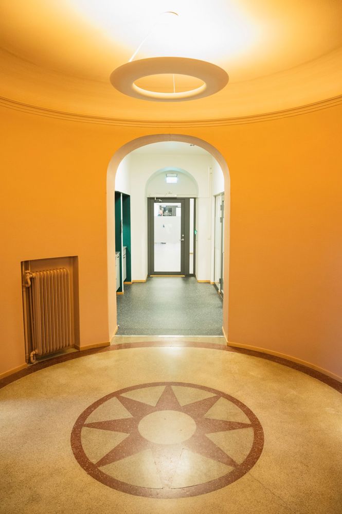 old and new, orange round walls in old area, round shaped floor with decorating tiles.