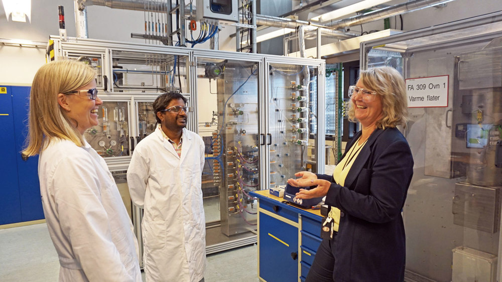 three people talking in a pilot lab