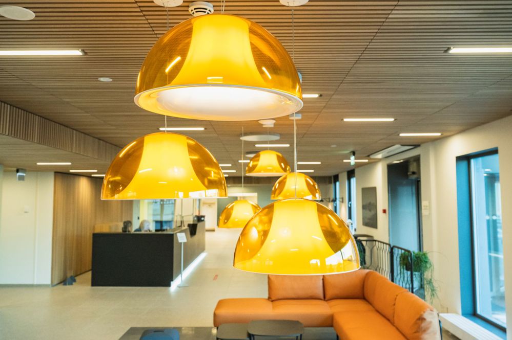 yellow lamps hanging down from ceiling, reception area