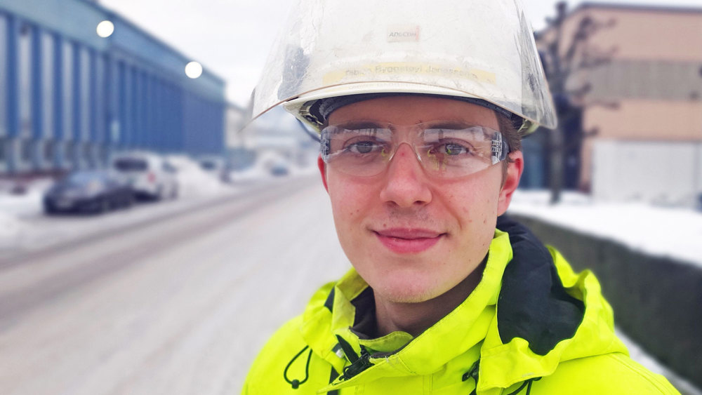 young man, apprentice, helmet and glasses, outdoors